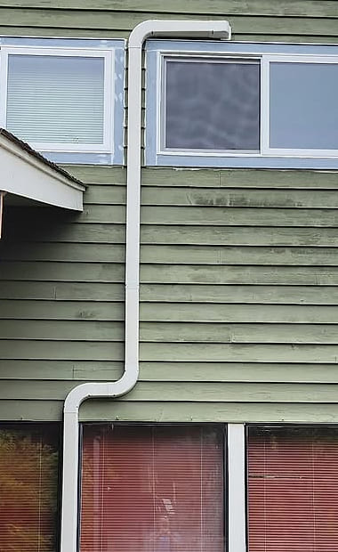 A line-set run boxed down painted siding with two square offsets.